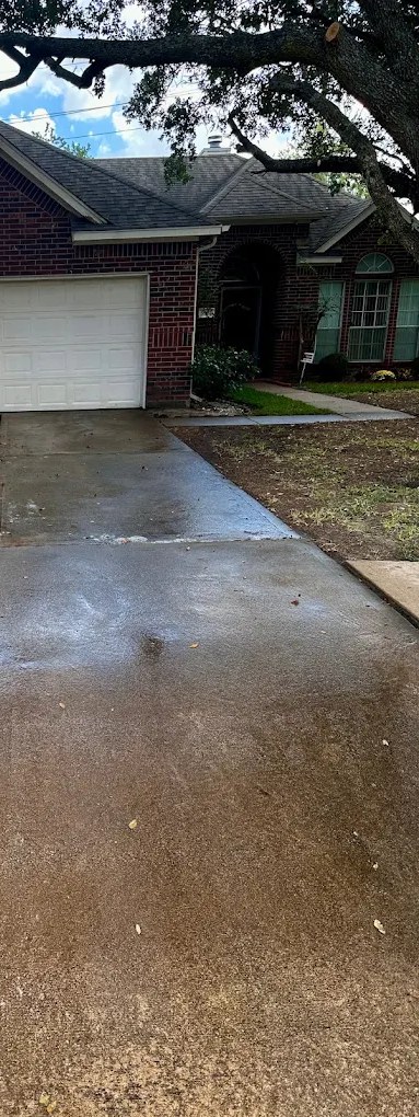 Same Houston driveway freshly soft-washed and rinsed clean, no etching or discoloration
