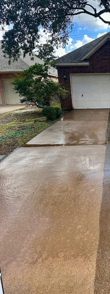 Dirty, stained Houston driveway before being pressure washed